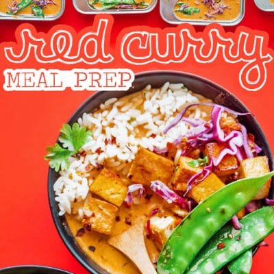 Thai red curry in a meal prep container with red background