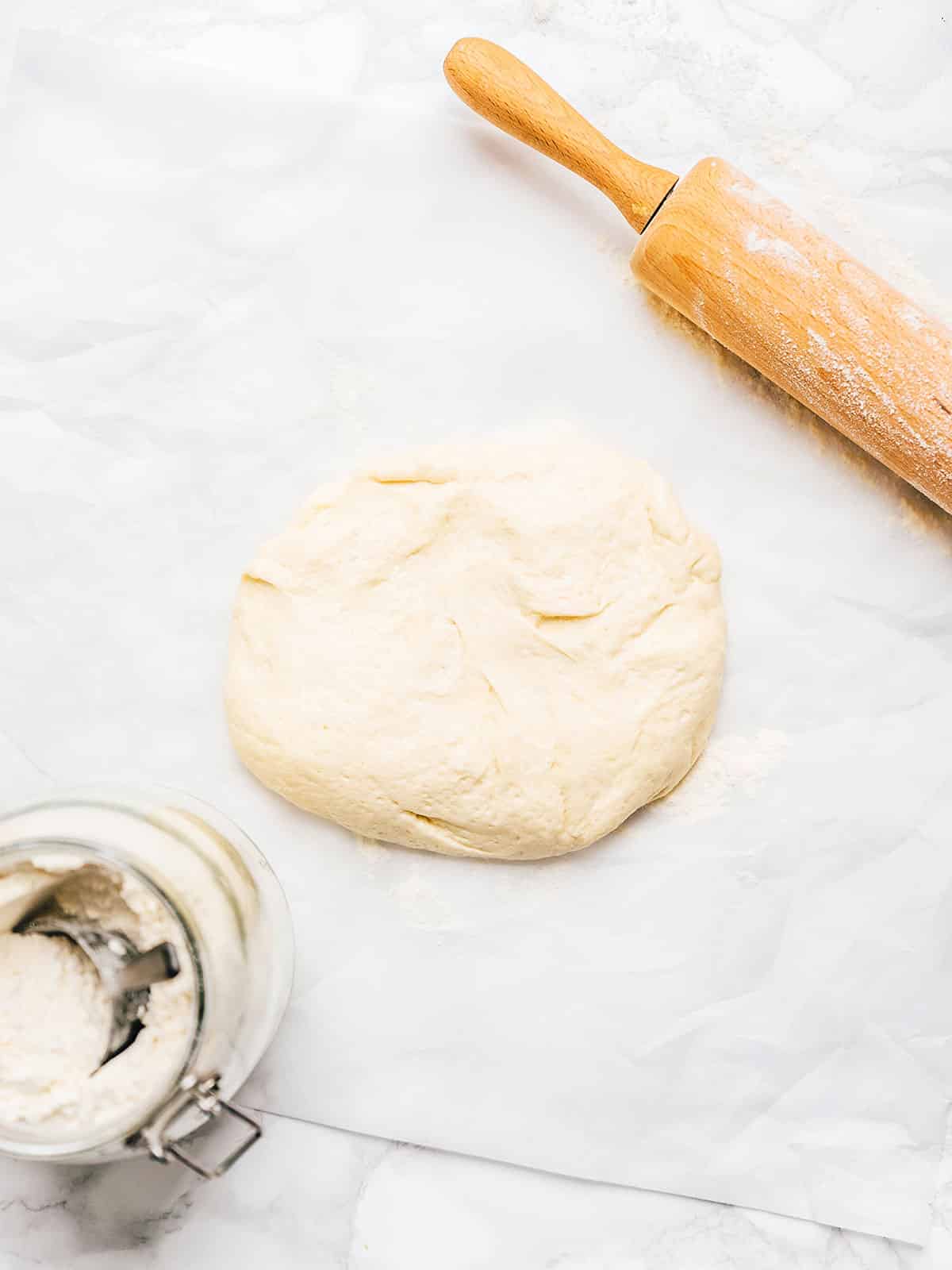 Pizza dough on a marble background.