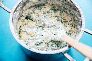 Greek yogurt spinach artichoke dip in a stove pan