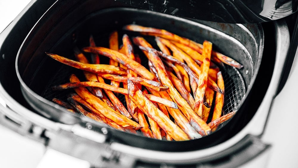 Cooking sweet potato fries in an air fryer basket