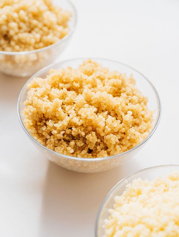 Couscous, quinoa, and pearl couscous in bowls on a white background
