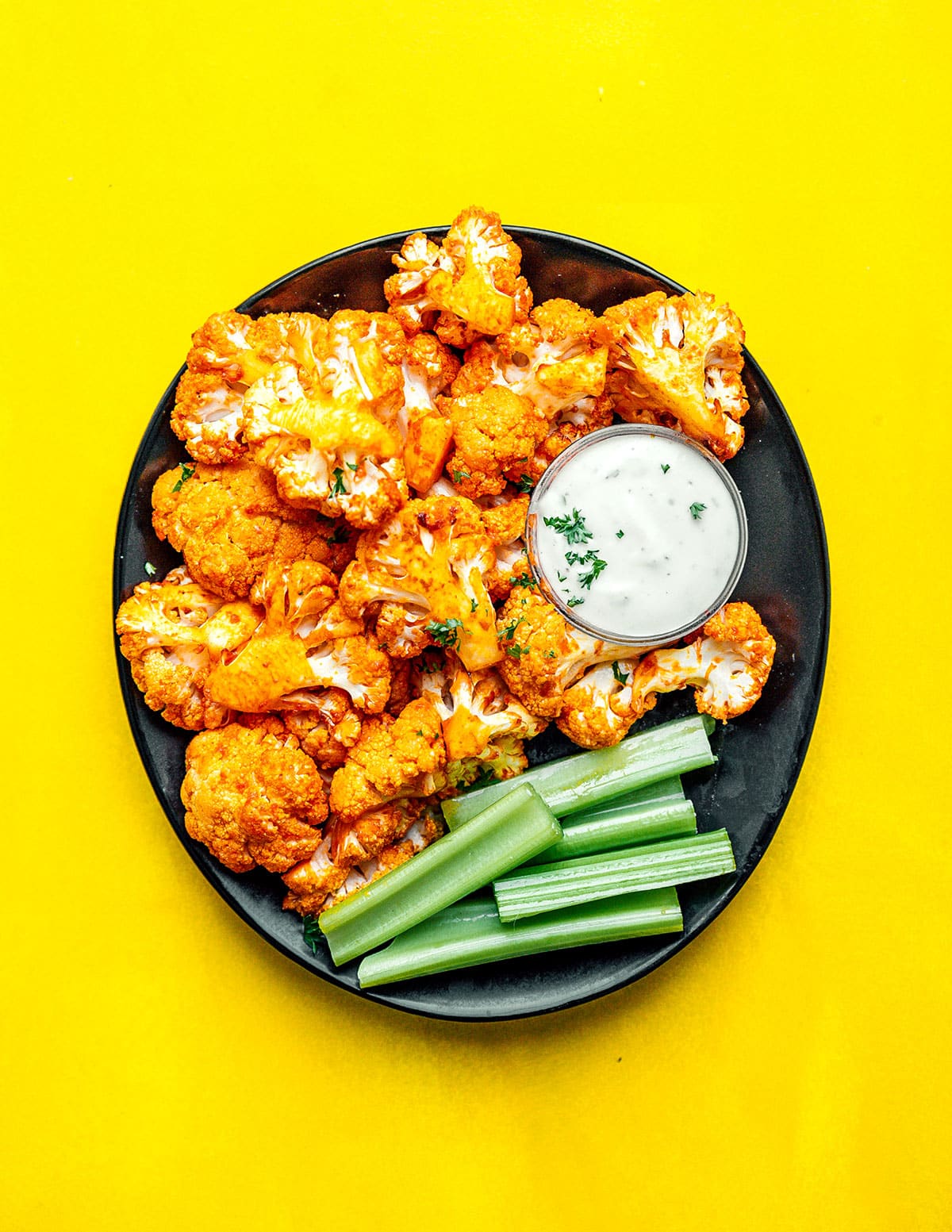 This Air Fryer Buffalo Cauliflower is an easy, vegan recipe that requires just 20 minutes to make and is complete with your favorite creamy dip!