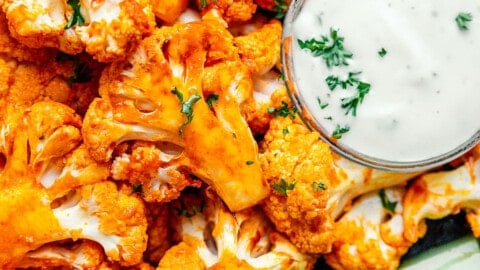 Air fryer buffalo cauliflower on a plate with celery.