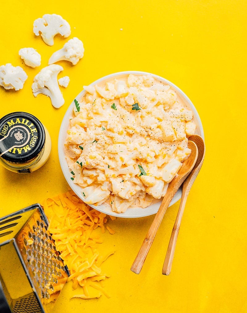 Keto mac and cheese in a bowl on a yellow background