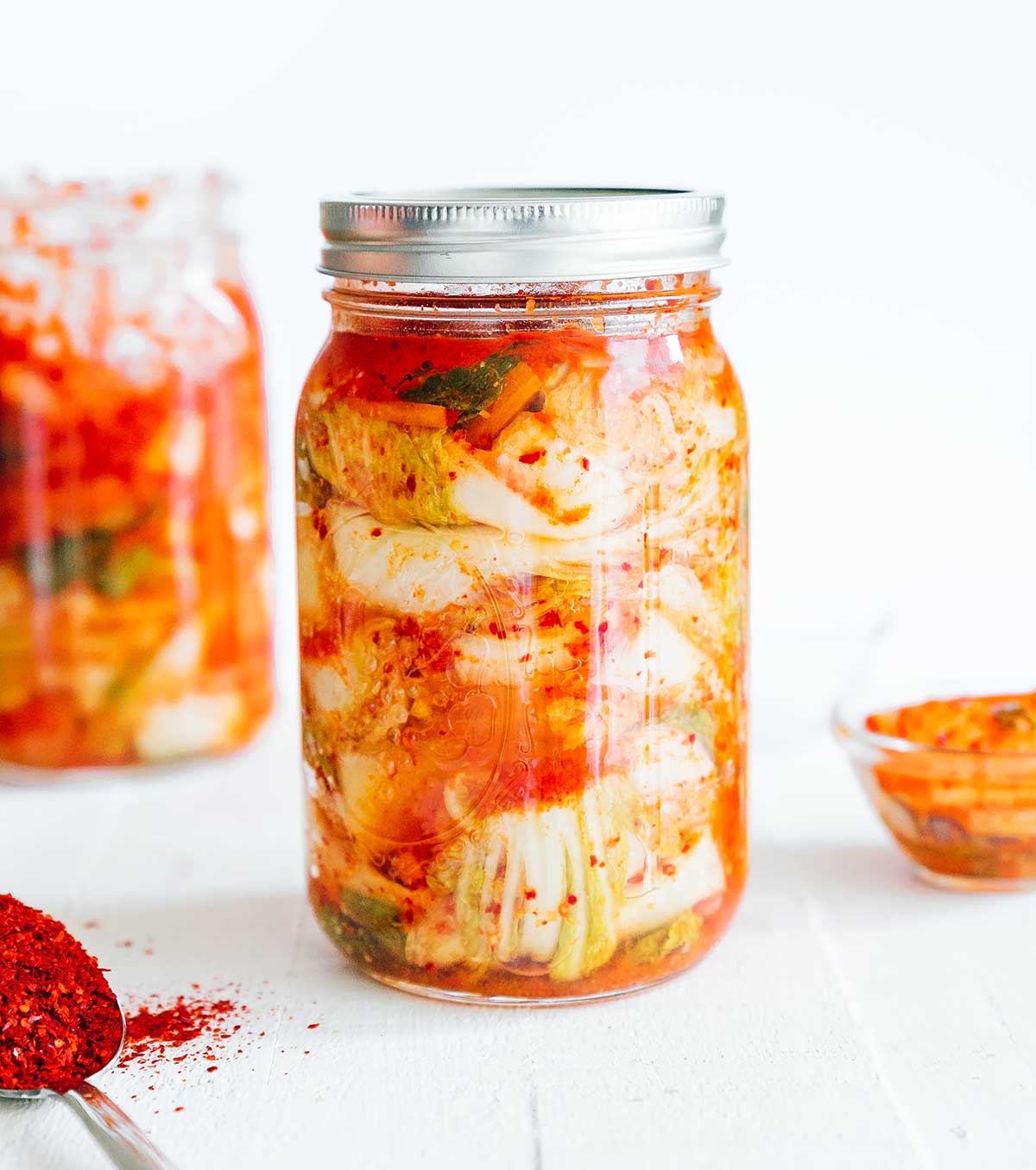 Homemade kimchi in a mason jar with white background
