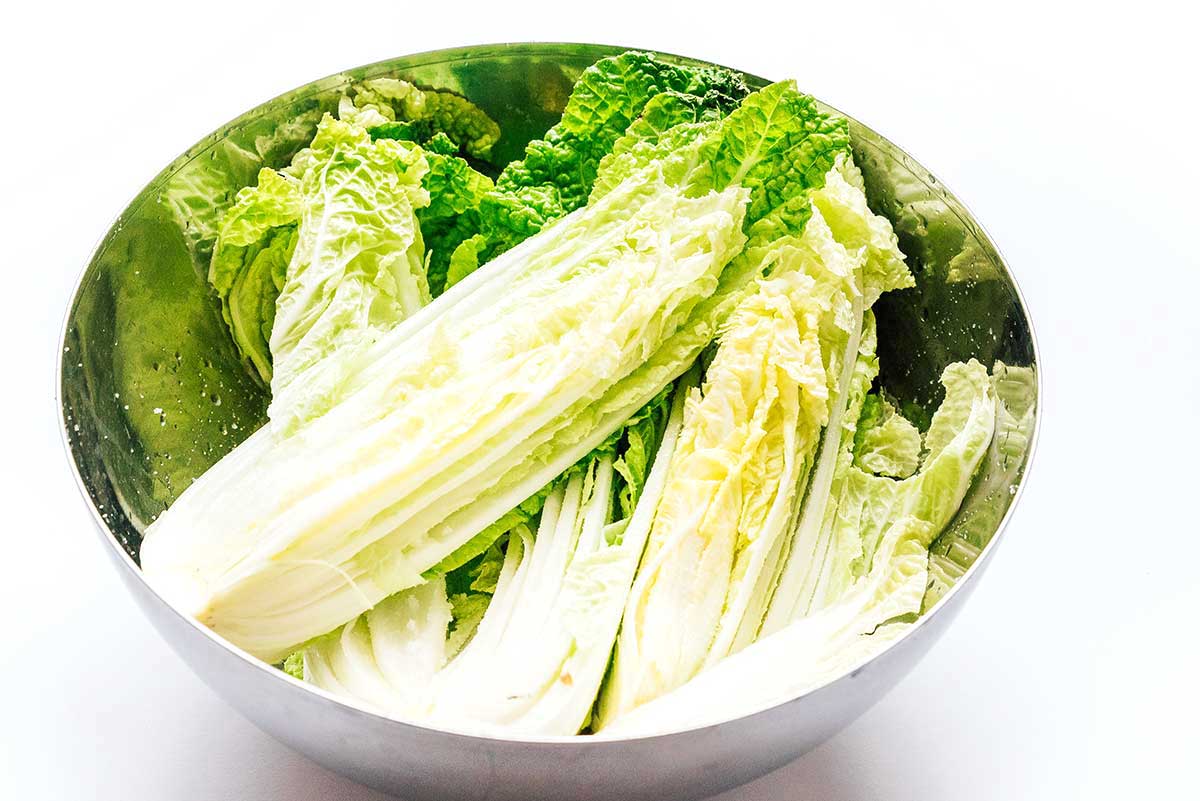 Fresh cabbage in a bowl on a white background