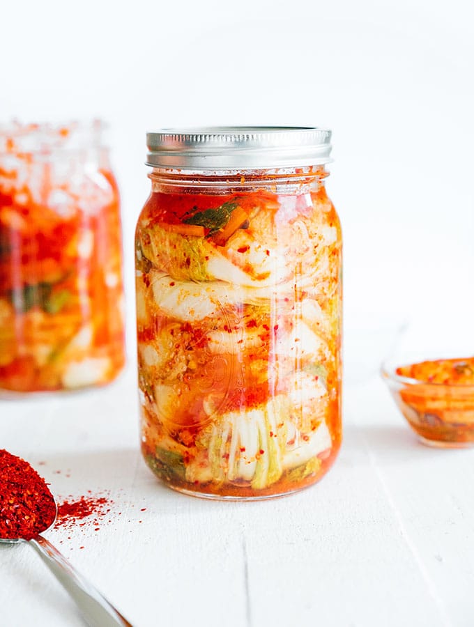 Homemade kimchi in a mason jar with white background