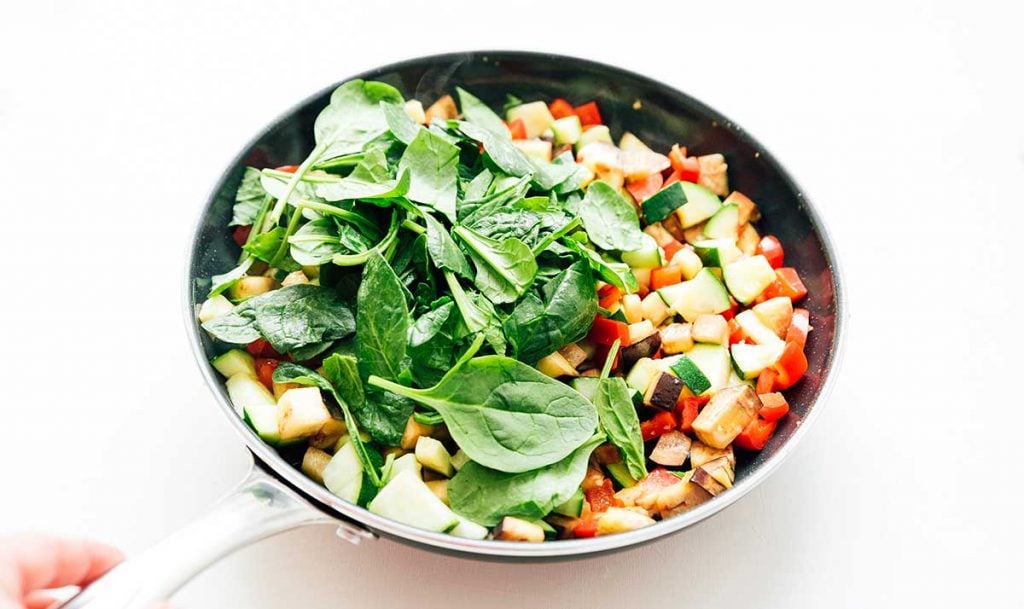 Mixed vegetables in a pan on a white background