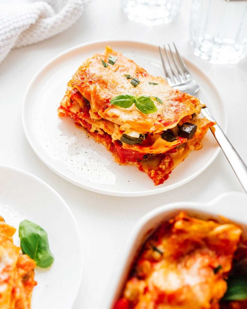 A plate of vegetarian lasagna on a white background