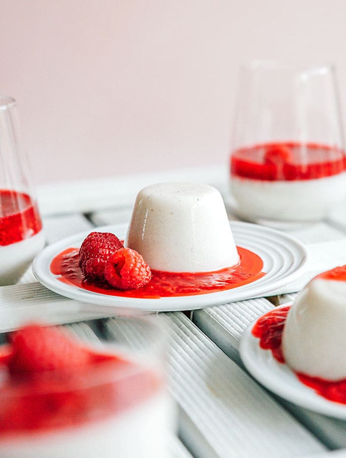 A dessert plate filled with panna cotta and raspberry topping