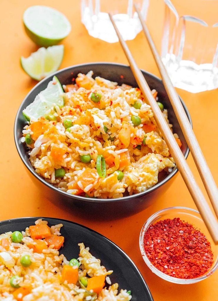 Detailed image of a bowl of kimchi fried rice on an orange background