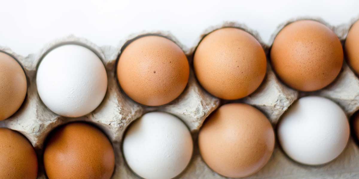 Brown and white eggs in a carton