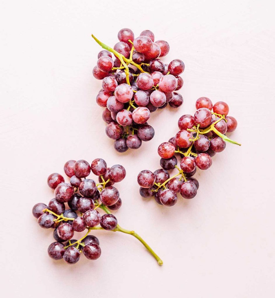 Three bunches of red seedless grapes 