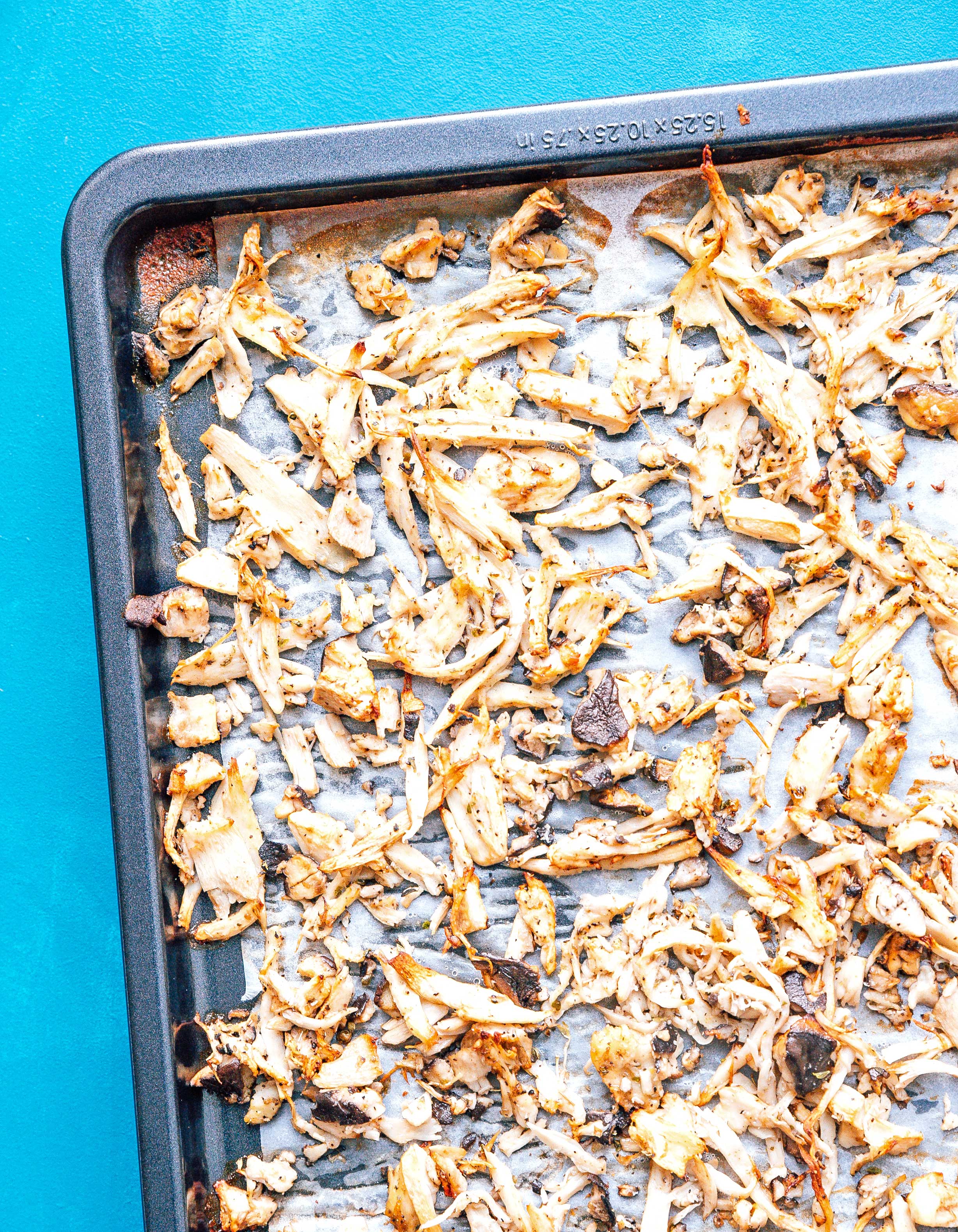 Baking sheet filled with cooked oyster mushrooms slices