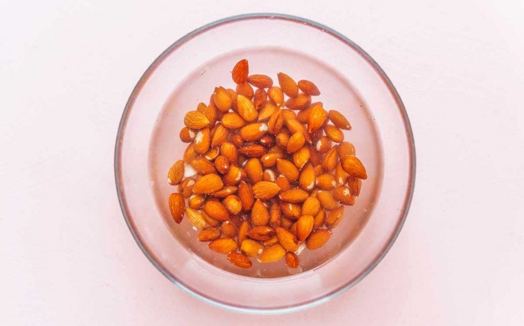 One cup of almonds soaking in a bowl of water