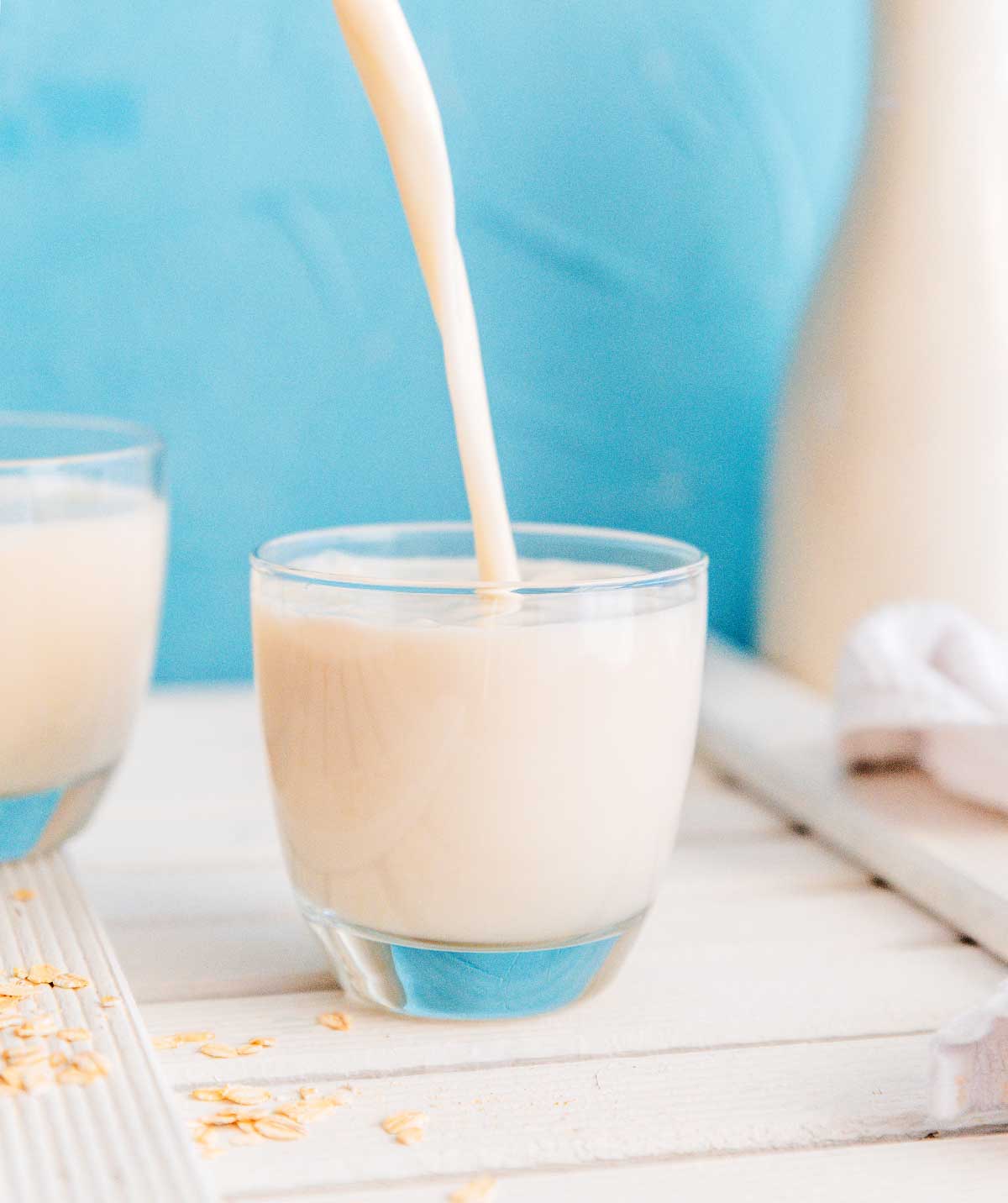 Oat milk being poured in a cup.
