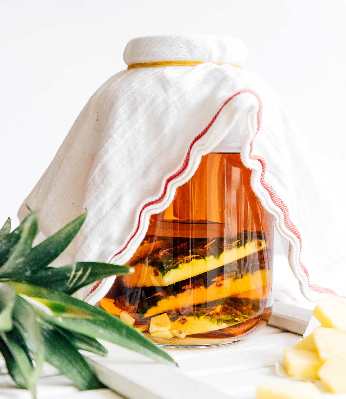 Making tepache in a glass jug on a white background