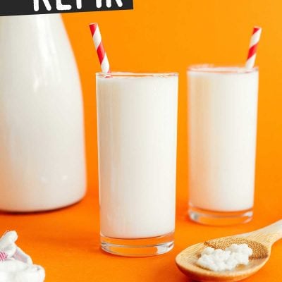 Kefir in a glass on an orange background