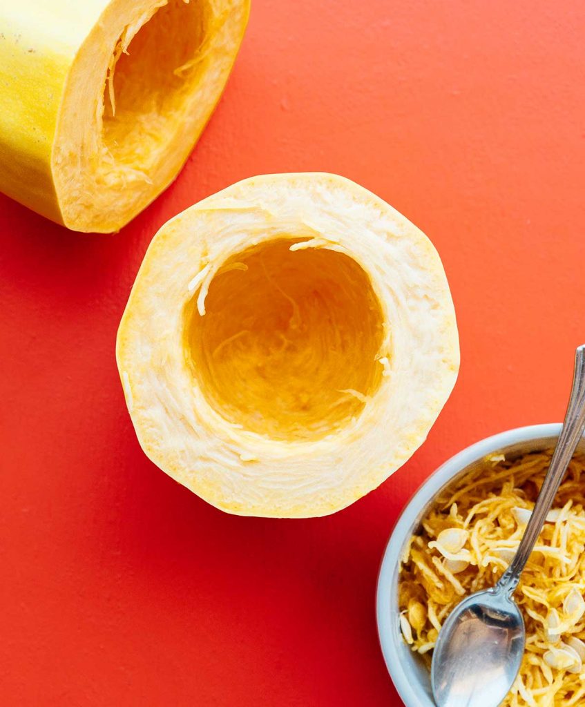 A spaghetti squash cut and half, hollowed out with the seeds removed