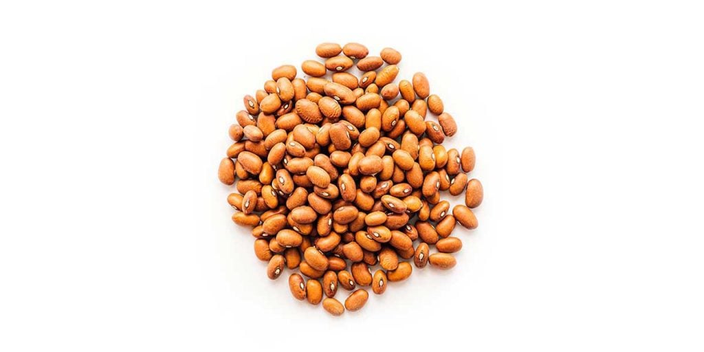 Dried brown beans on a white background
