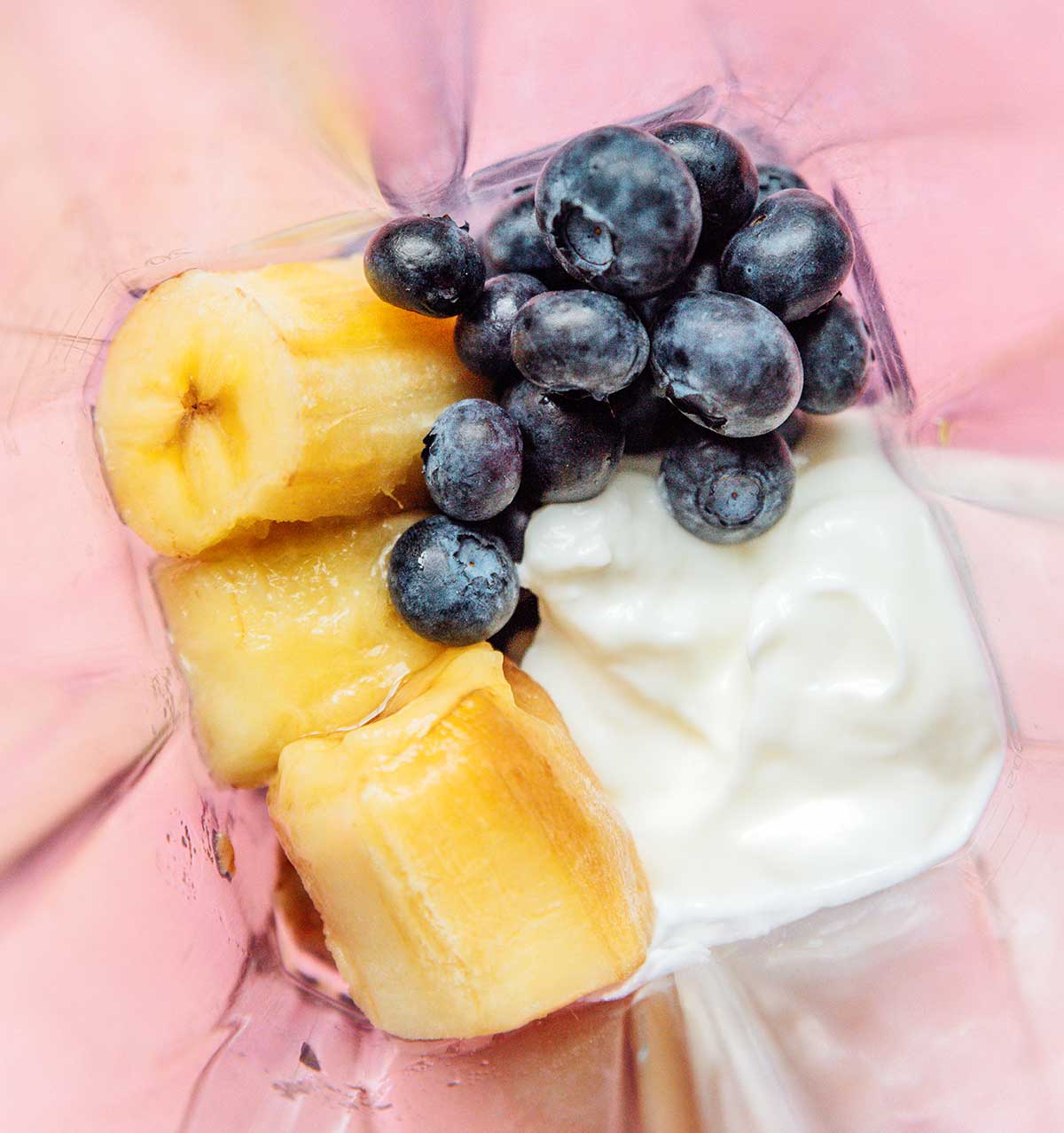 Blueberries, banana, and yogurt in blender. 
