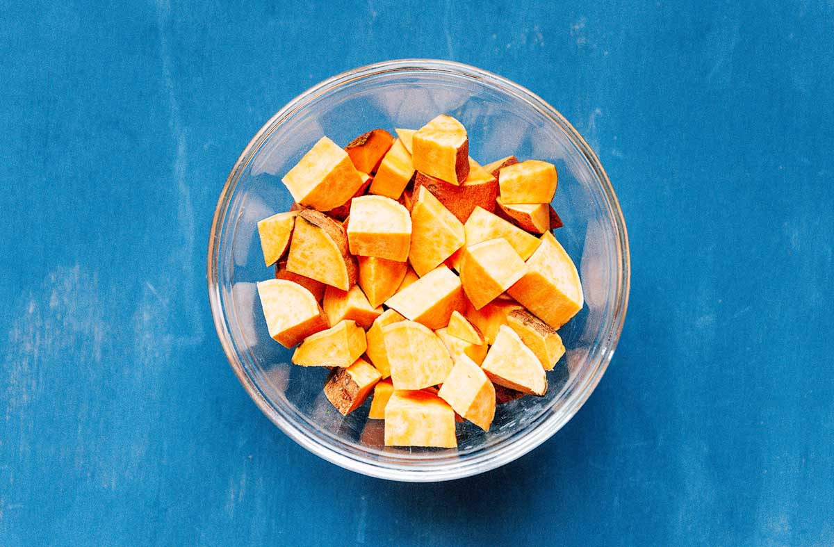 A bowl filled with diced sweet potato 