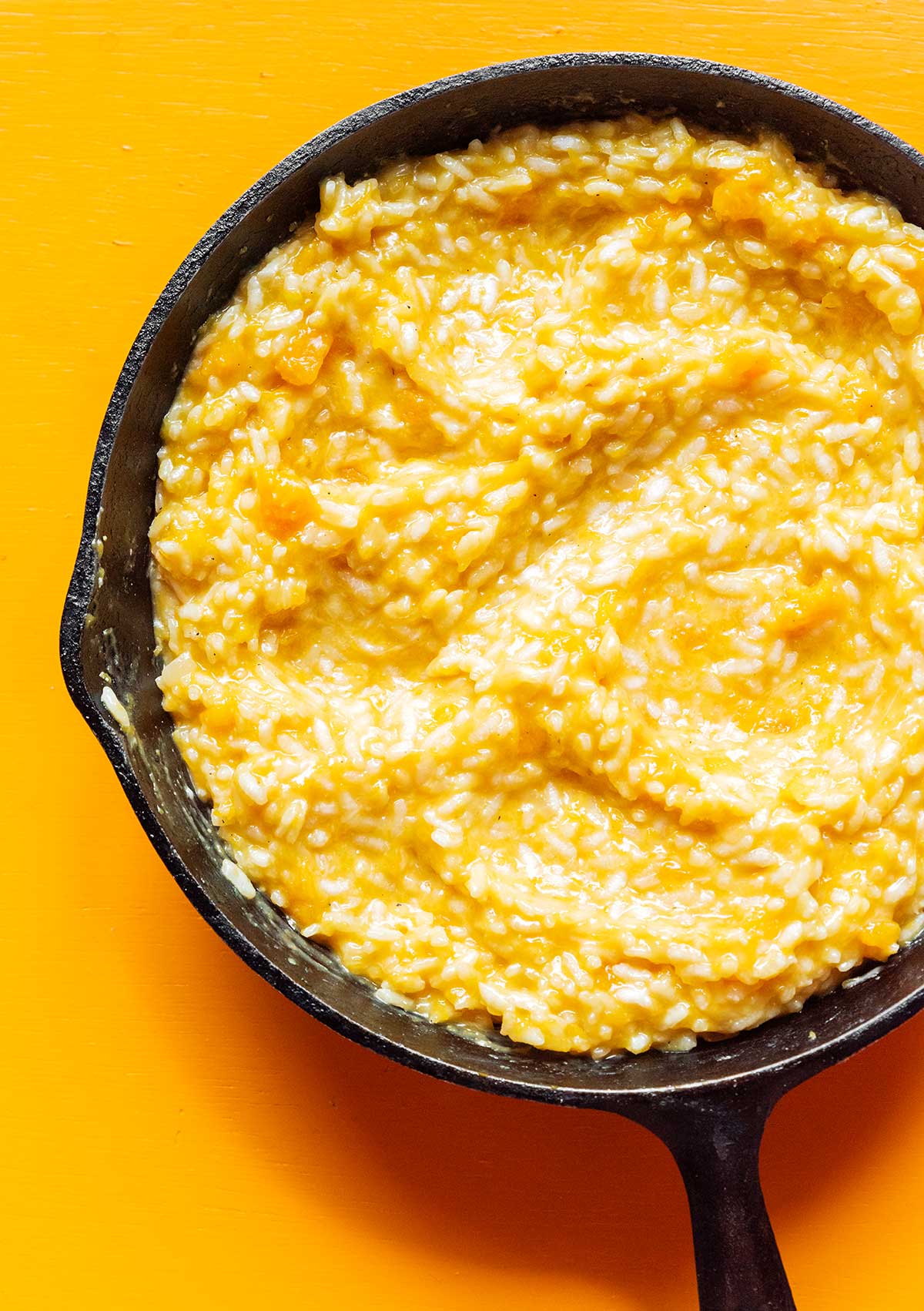 A cast iron skillet filled with creamy butternut squash risotto 
