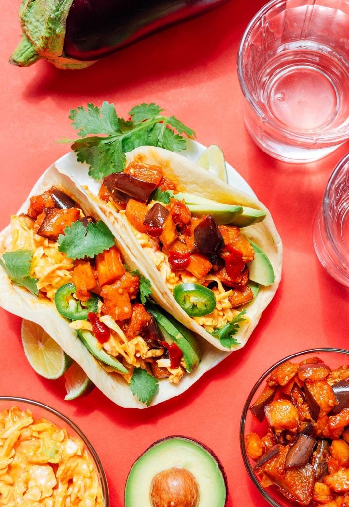 Korean eggplant tacos on a red background