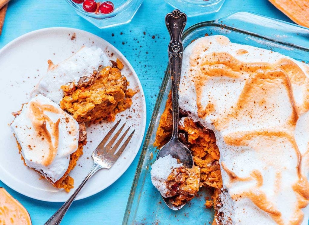 Sweet potato casserole with meringue on a blue background