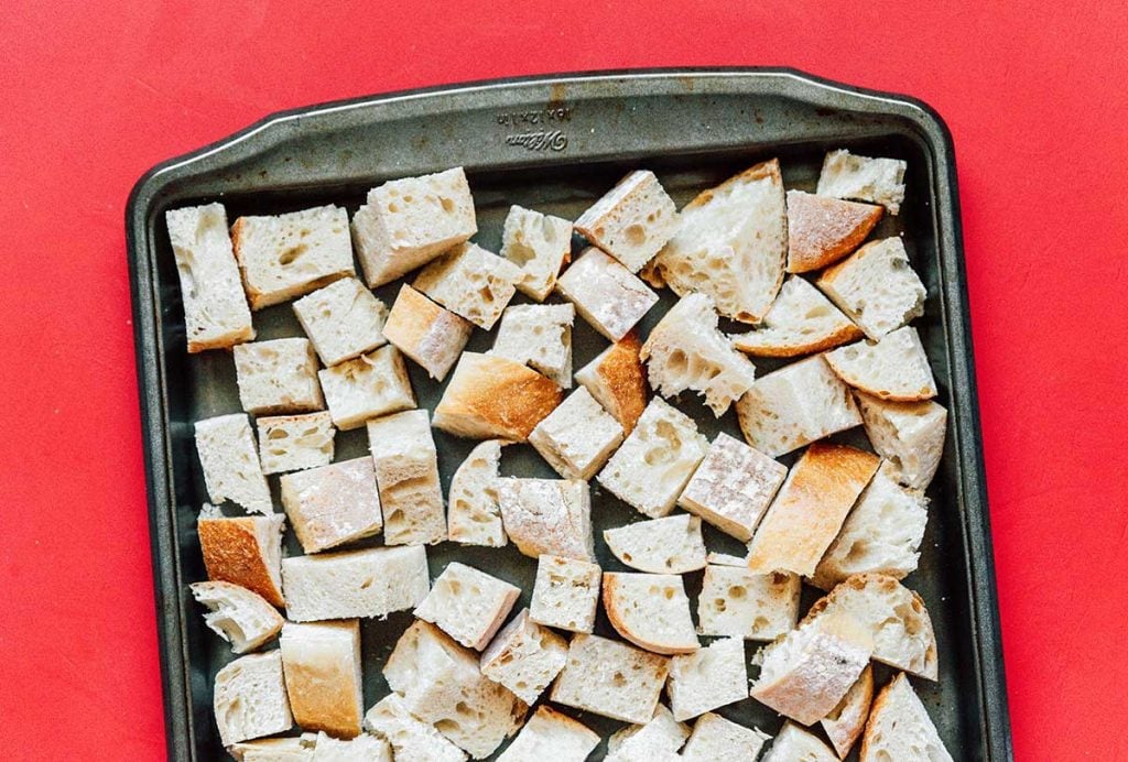 A sheet pan lined with cubed sourdough bread