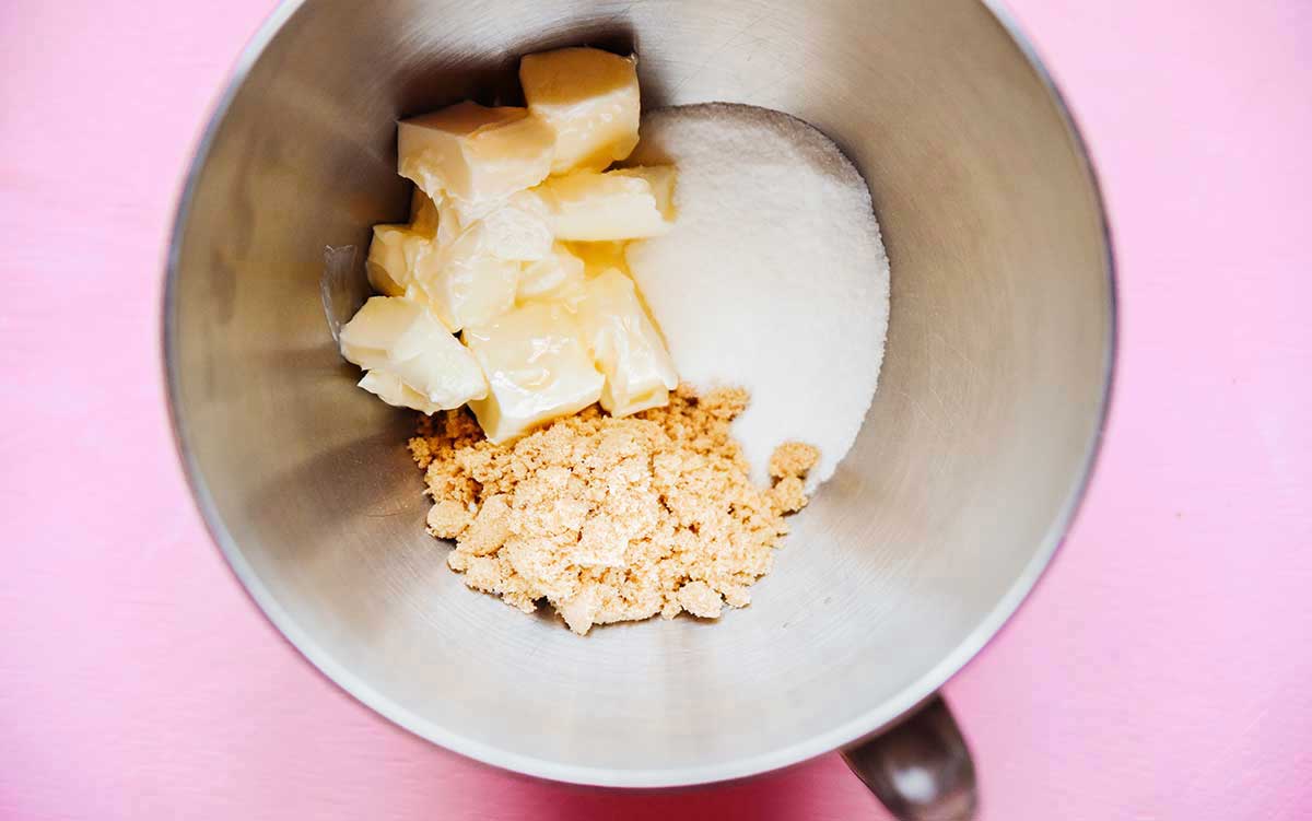 Butter, white sugar, and light brown sugar in a metal mixing bowl