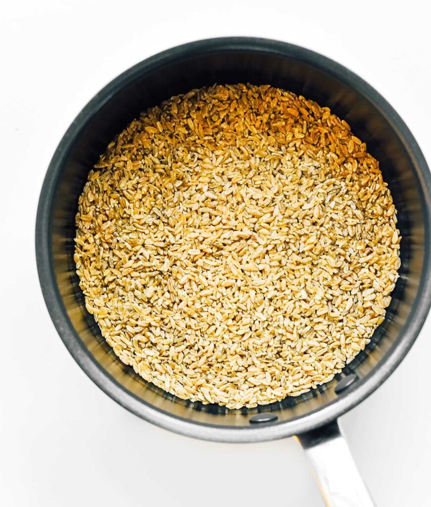 A sauce pot filled with uncooked freekeh