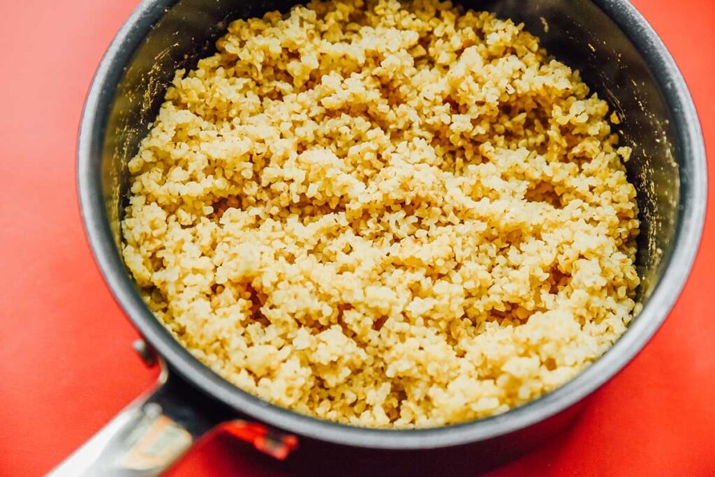 A sauce pot filled with freshly cooked and fluffed bulgur