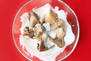 Marinating mushrooms in buttermilk.