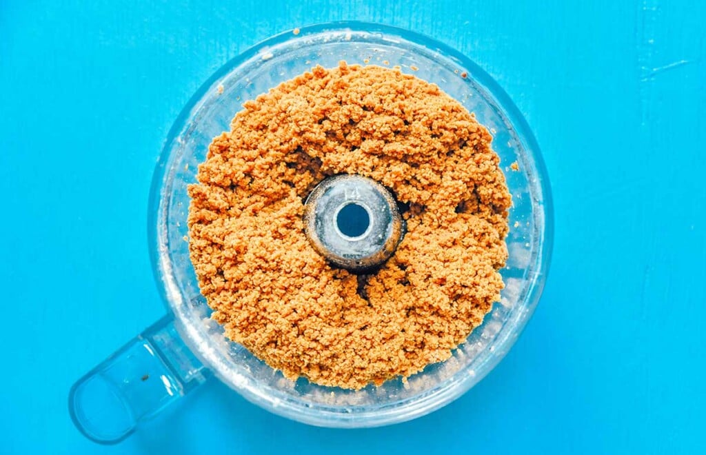 A food processor filled with various seitan burger ingredients