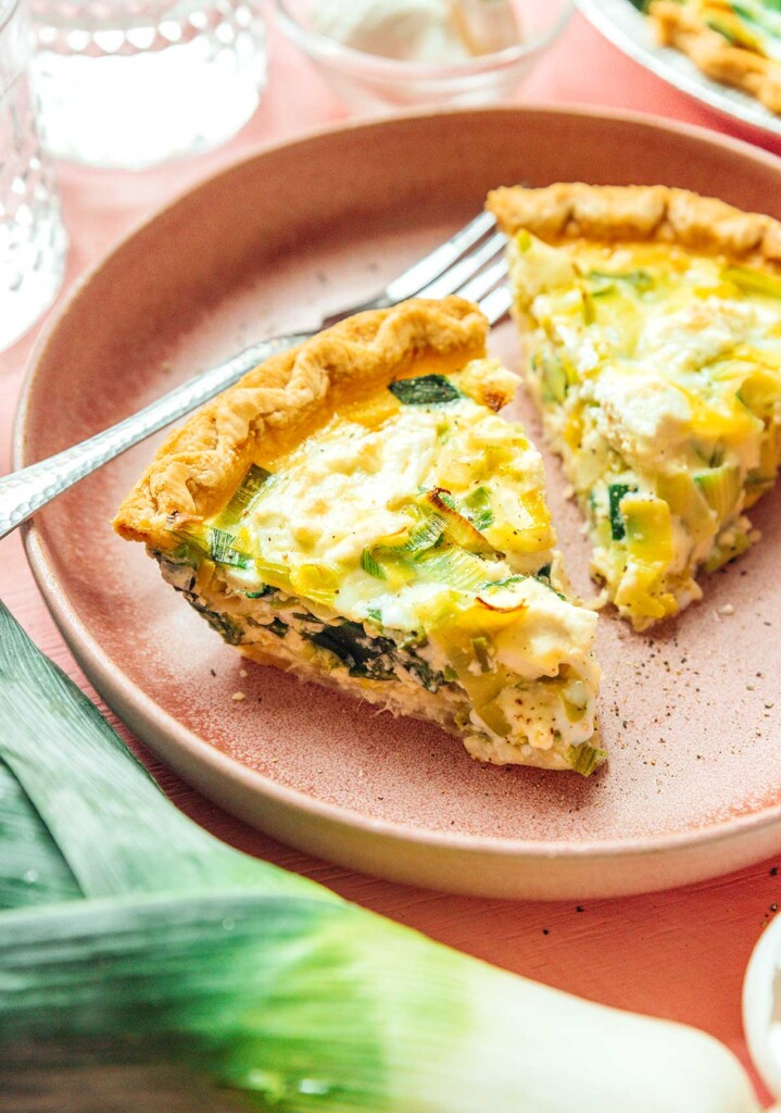 A plate filled with two thick pieces of goat cheese and leek quiche