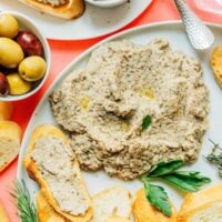 Mushroom pate on a plate next to toasted bread.