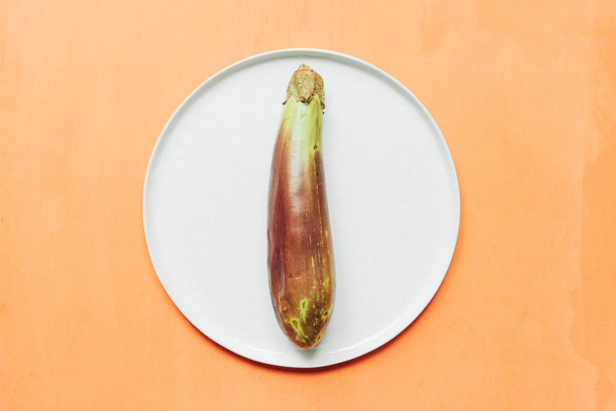 A Filipino eggplant on a white plate