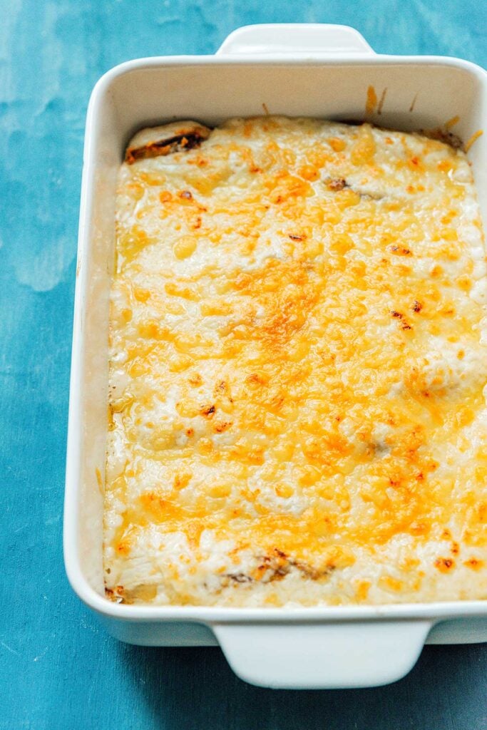 A close up image detailing the texture of broiled Belgian endive gratin