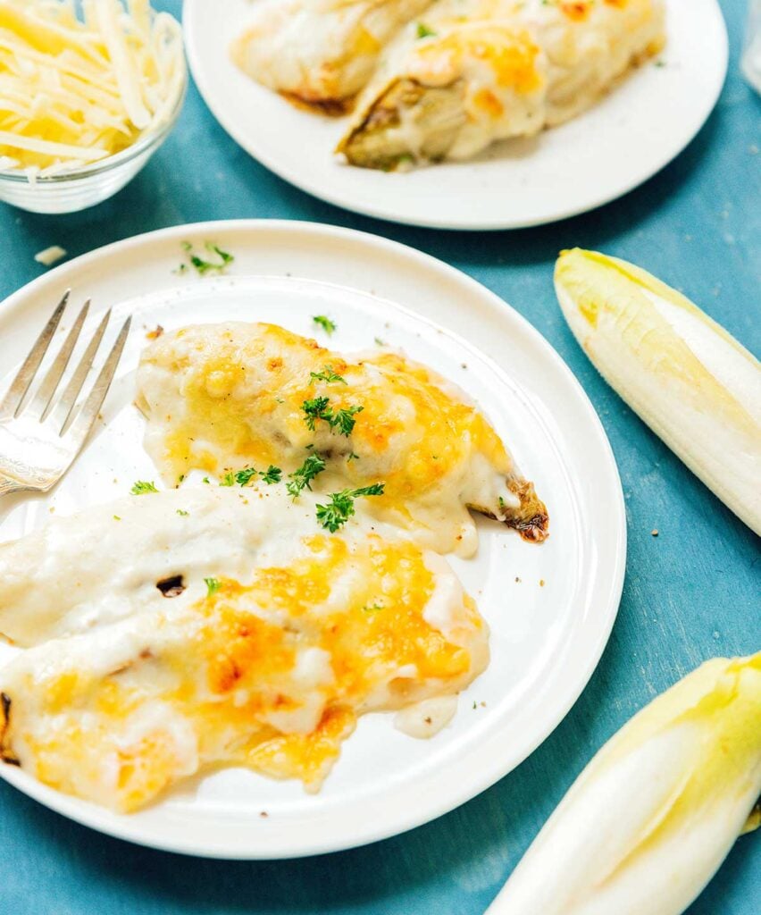 Two servings of endive gratin on a white plate