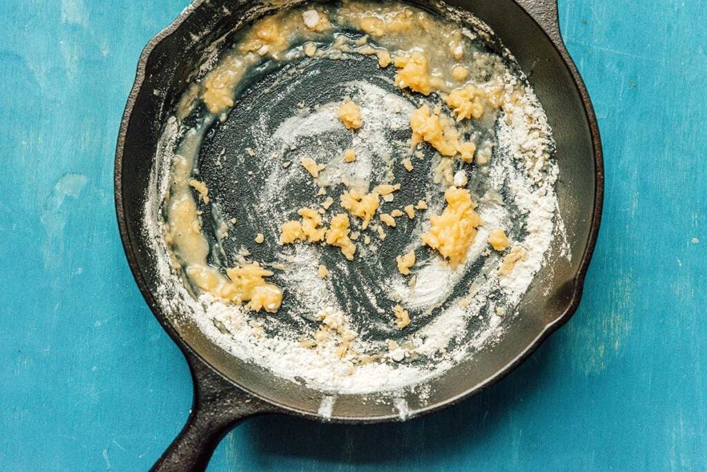 A cast iron skillet filled with butter and flour