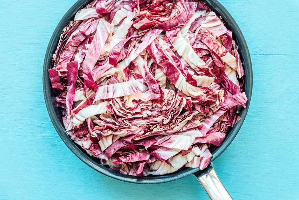 A skillet filled with slices of radicchio lettuce