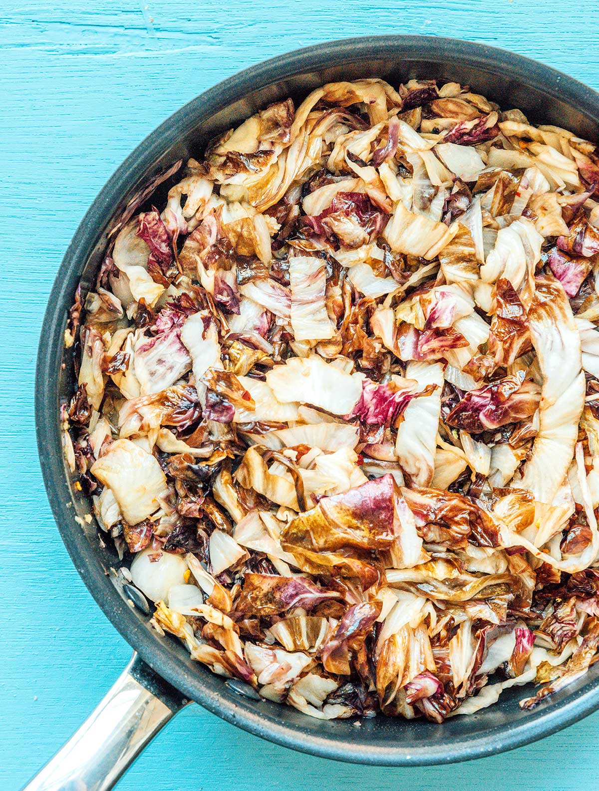 A skillet filled with cooked radicchio lettuce