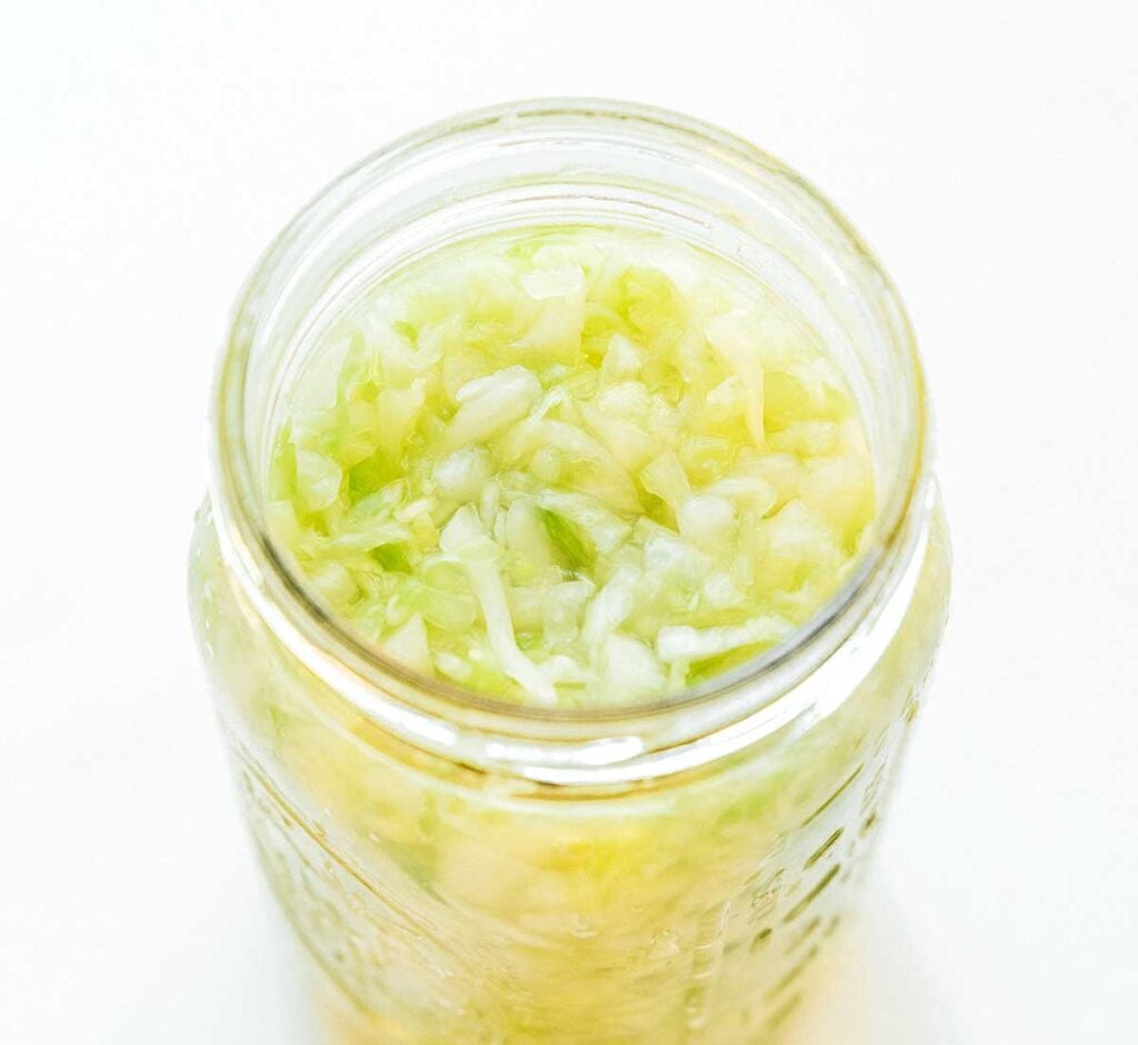 A jar filled with cabbage and water