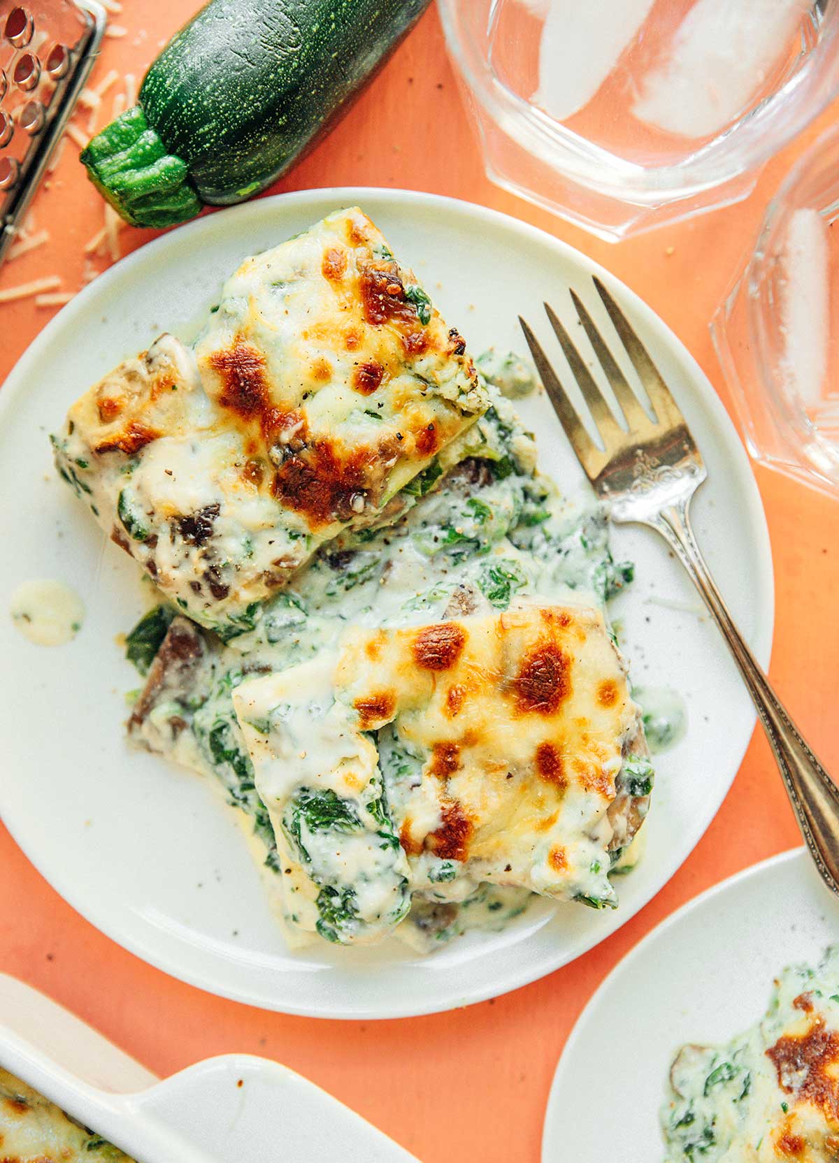 A white plate filled with two large servings of zucchini lasagna 