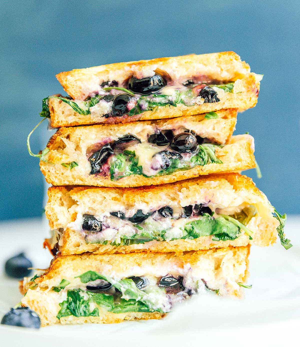 Four blueberry grilled cheese sandwich halves stacked on top of one another