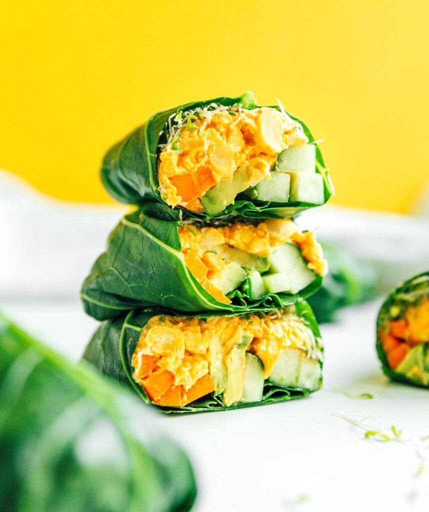 Three buffalo chickpea collard green wrap halves stacked on top of one another