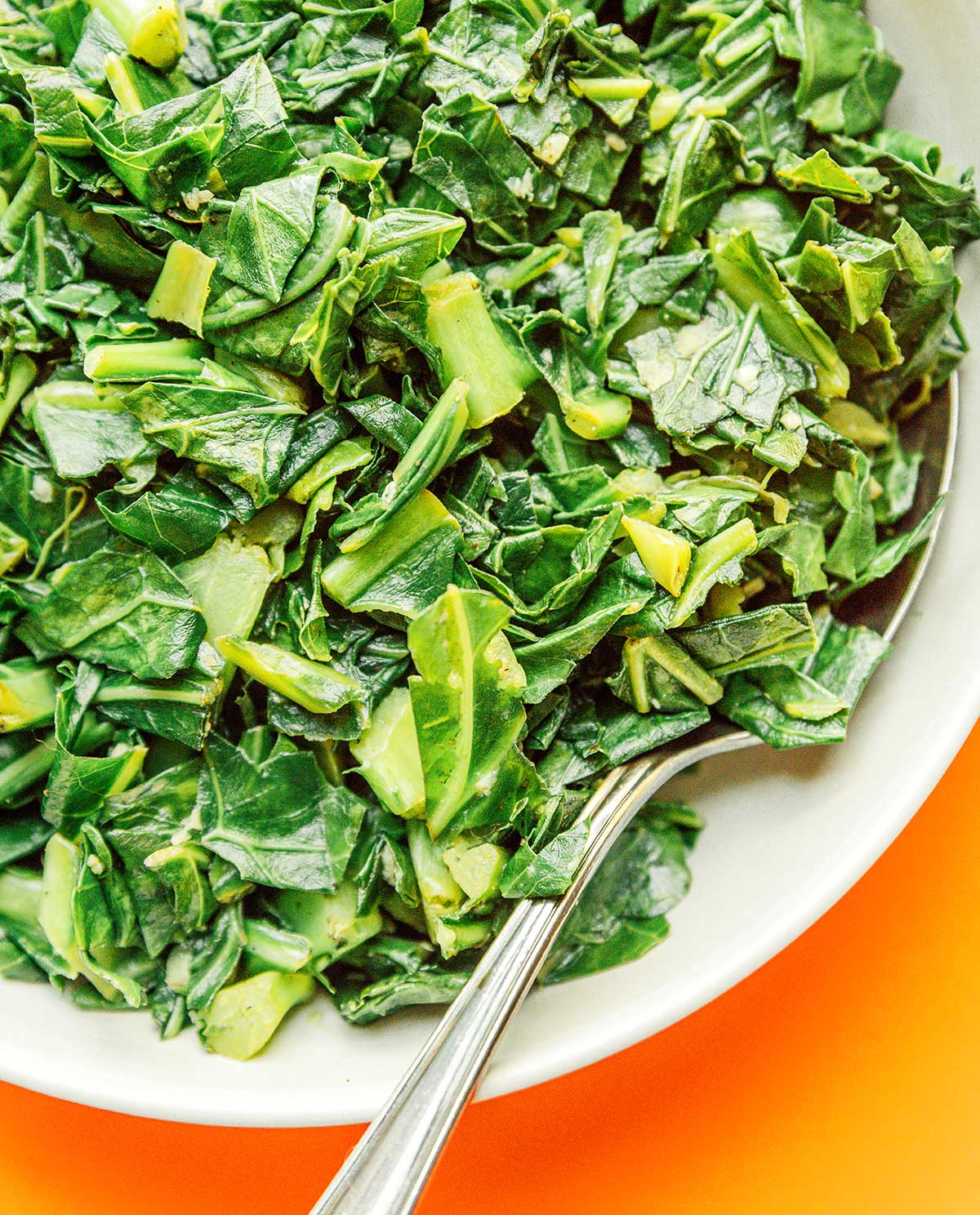 An up close look detailing the texture of chopped and sautéed collard greens