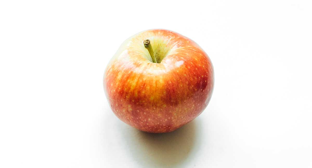 One gala apple on a white background