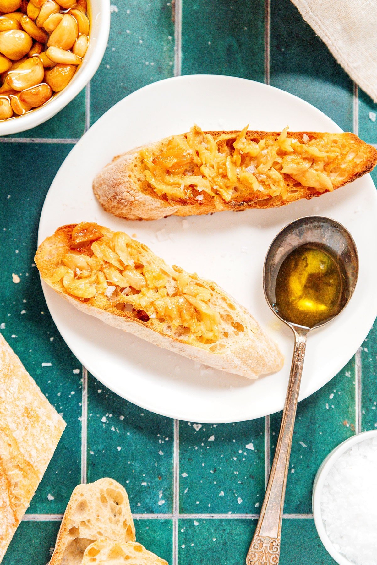 Two slices of toasted bread topped in garlic confit spread